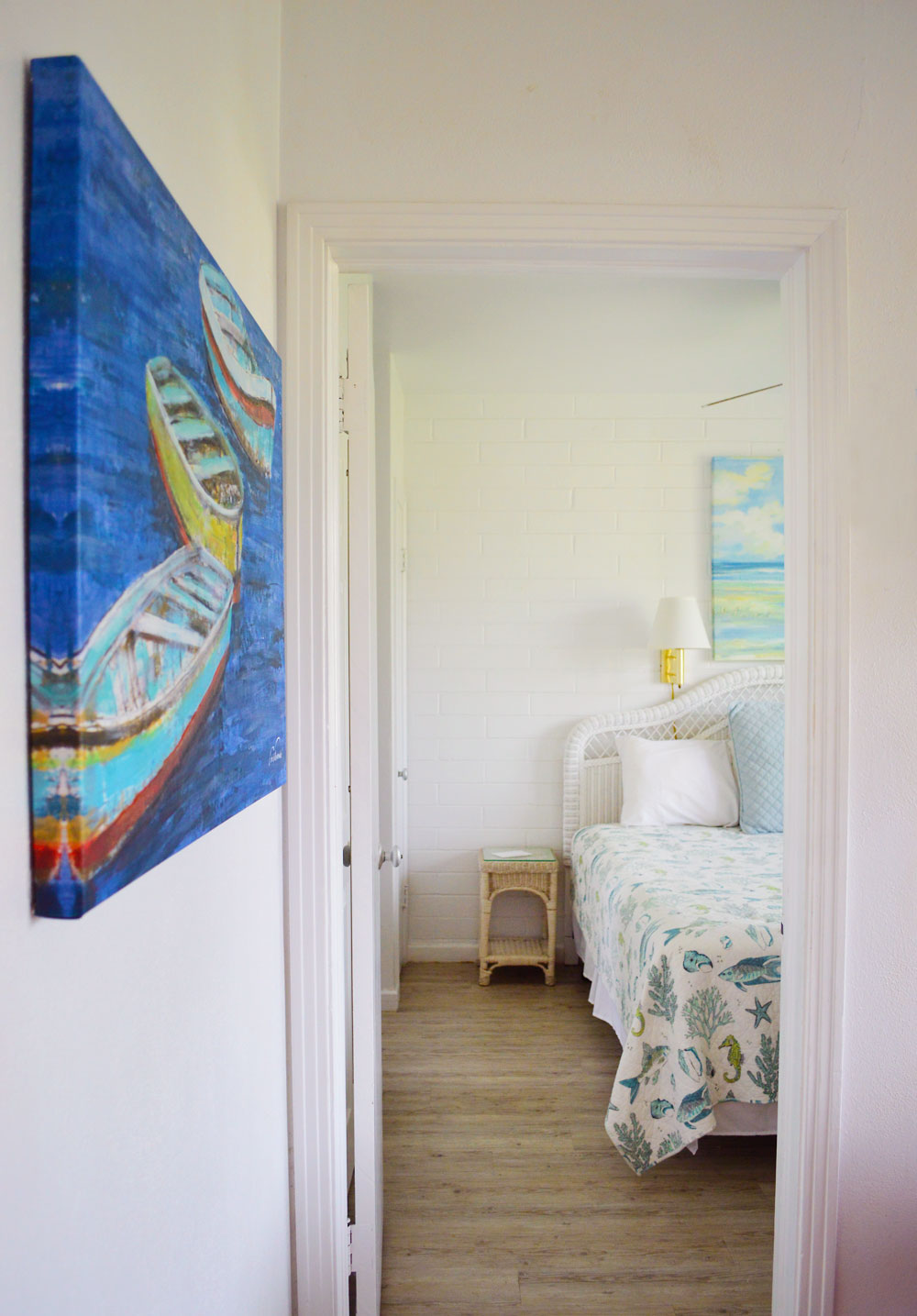 Peak of hallway art and Buena Vista Inn cozy bedroom