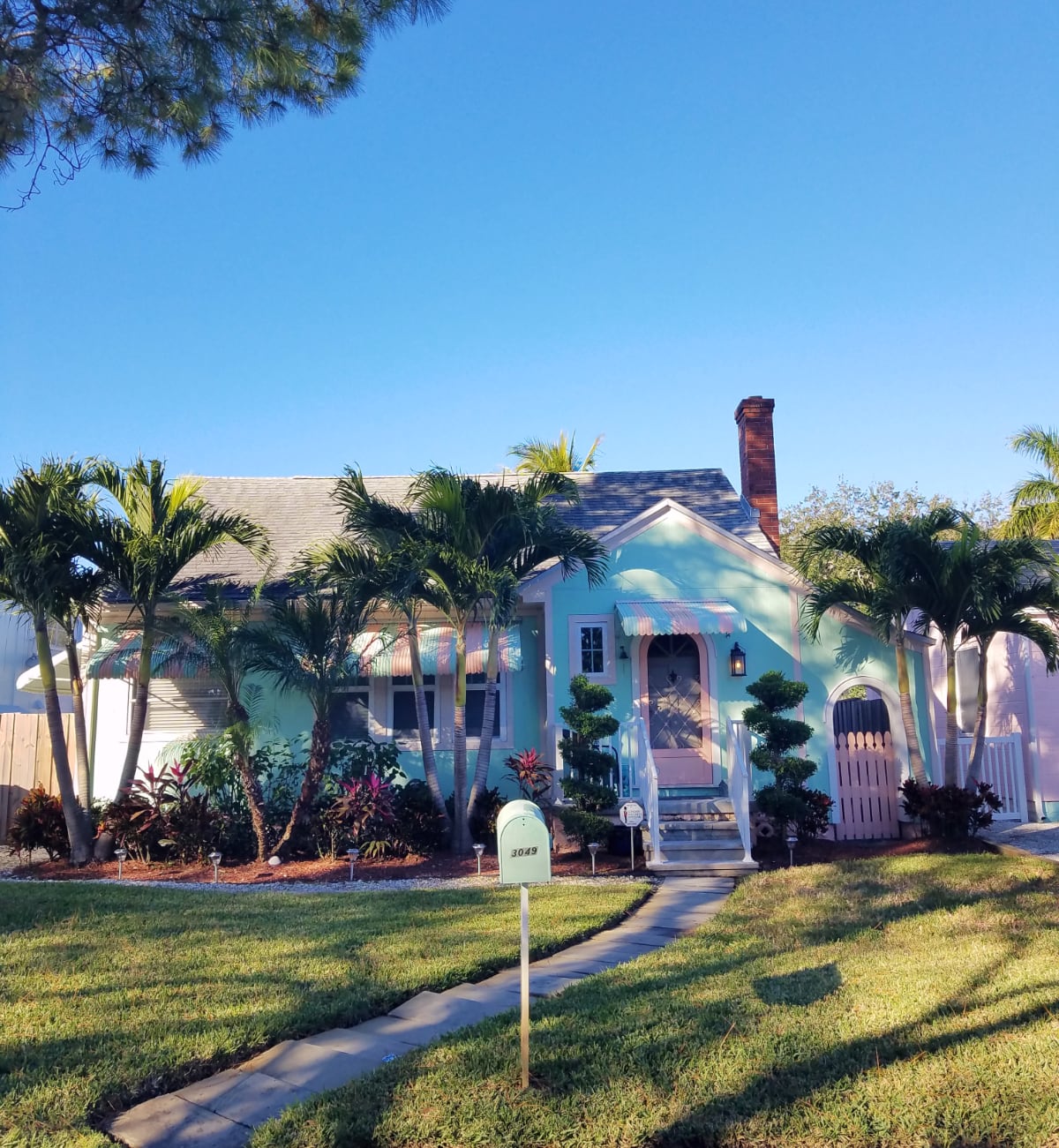 A sweet turquoise cottage with pink trim in Gulfport Florida
