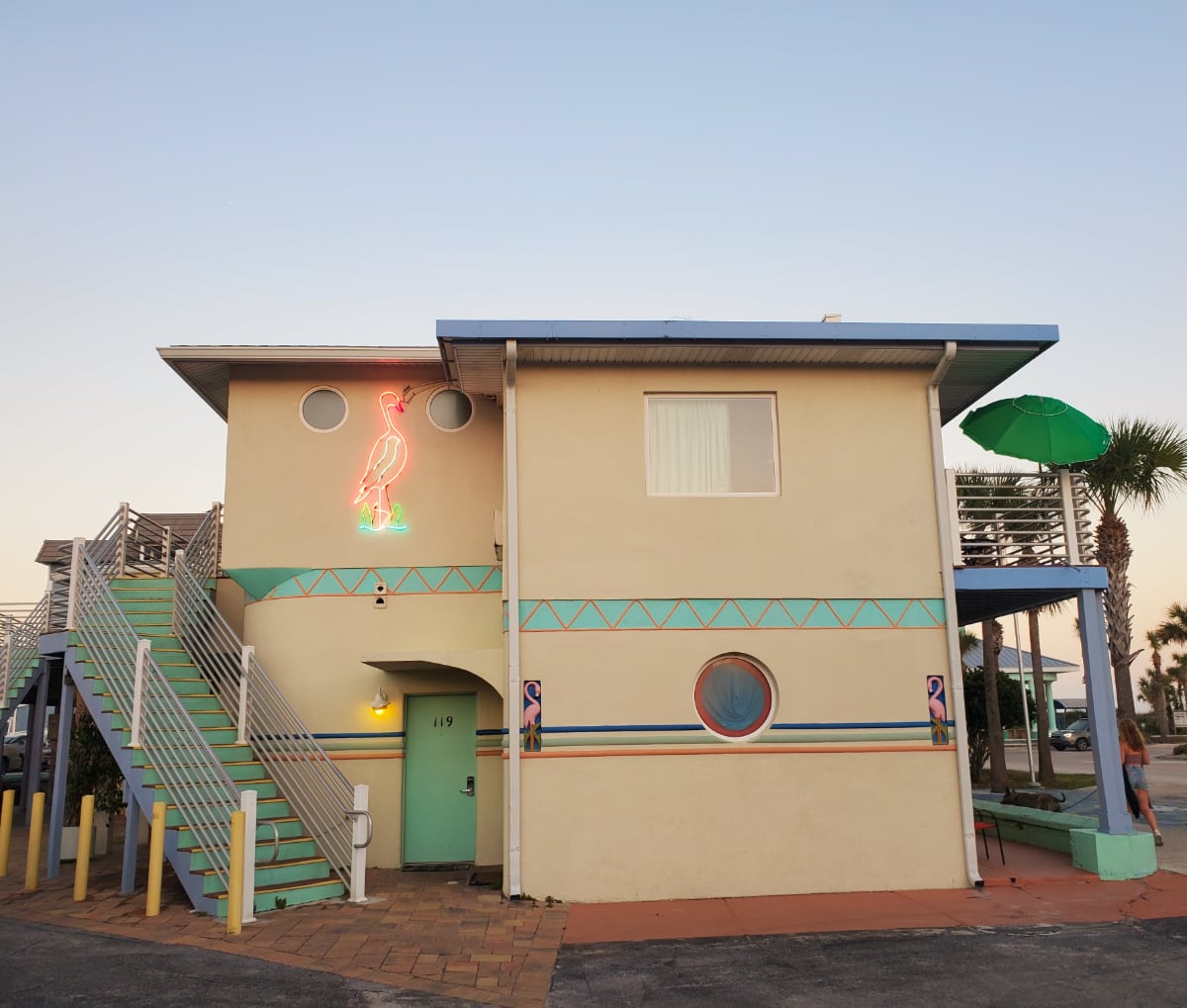 Magic Beach Motel 2-story building side with neon flamingo Vilano Beach