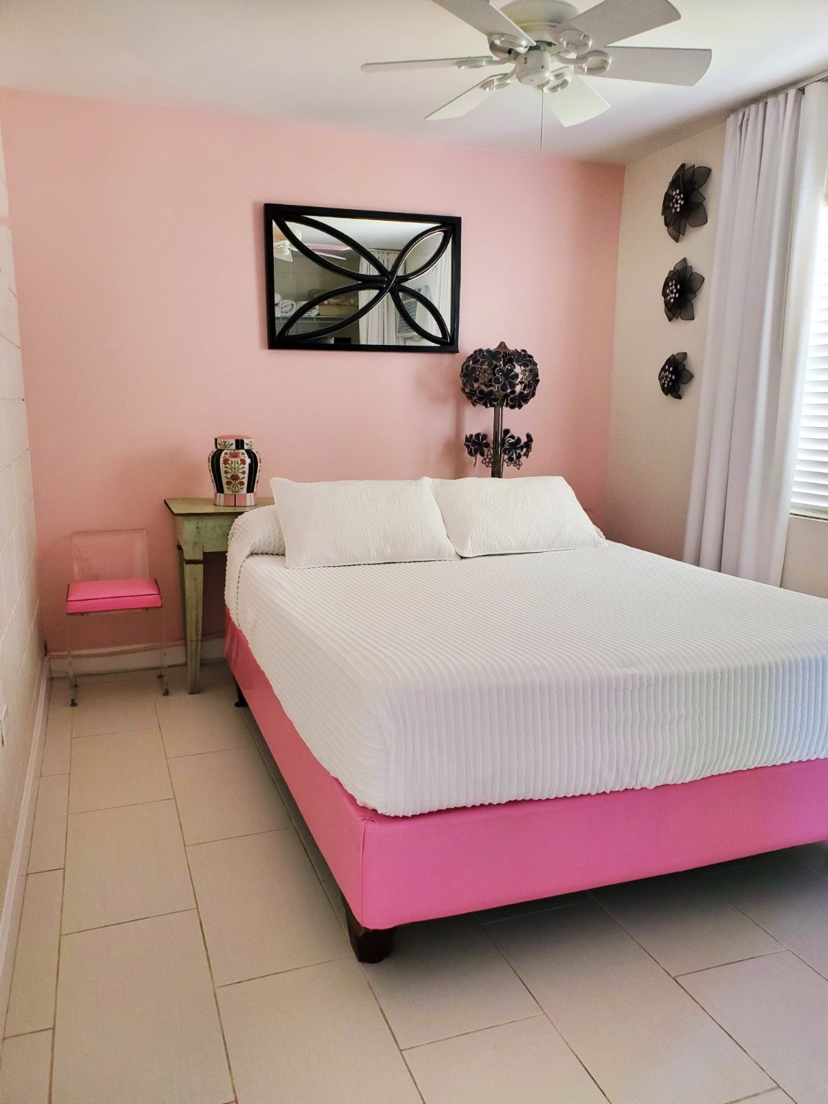 South Beach Place Pink Lady bedroom with its clever use of a console behind the bed, as headboard and for nightstand-type utility