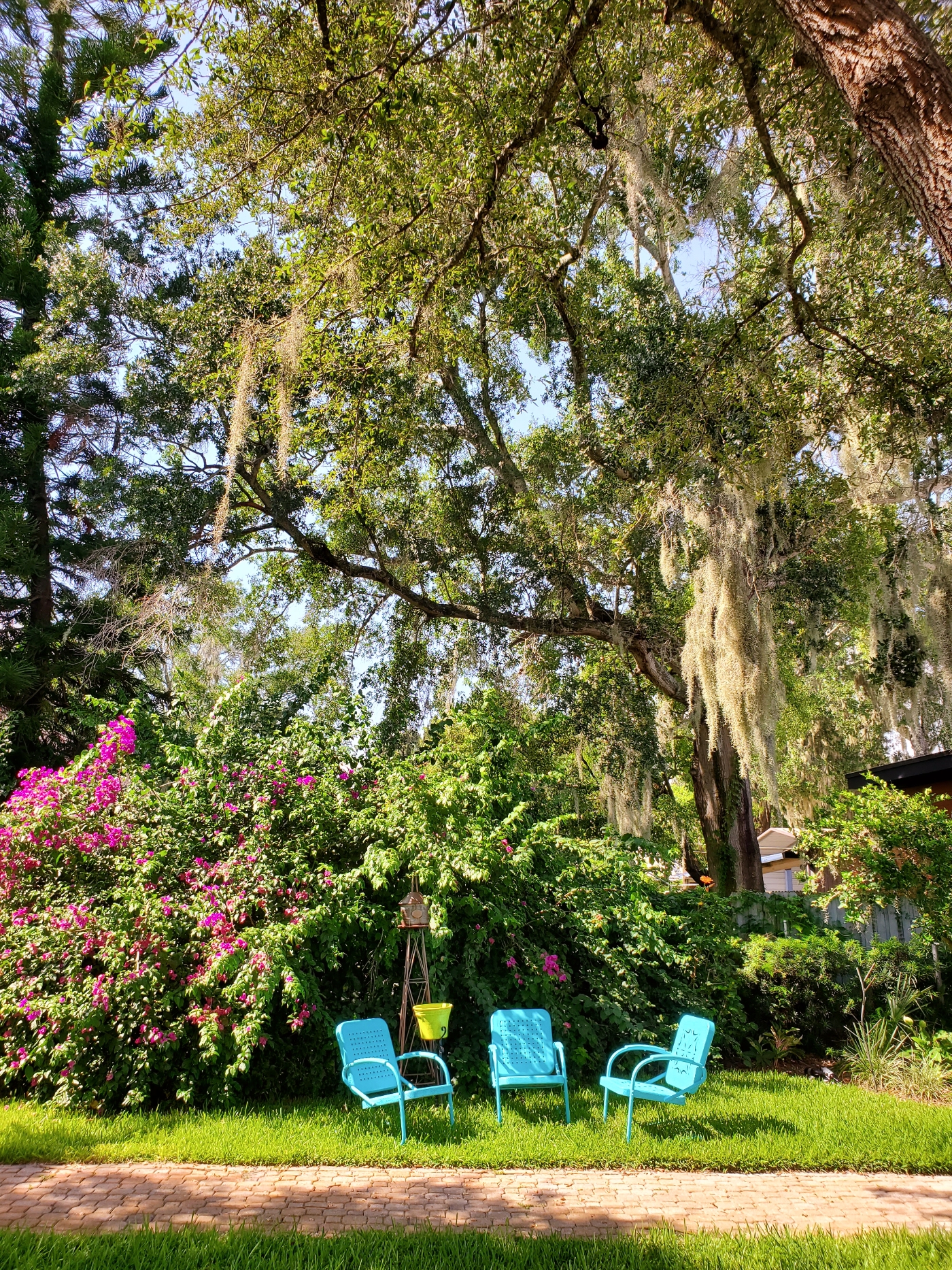 Random brightly painted metal porch chairs beckon to passersby to sit awhile, downtown Ocoee